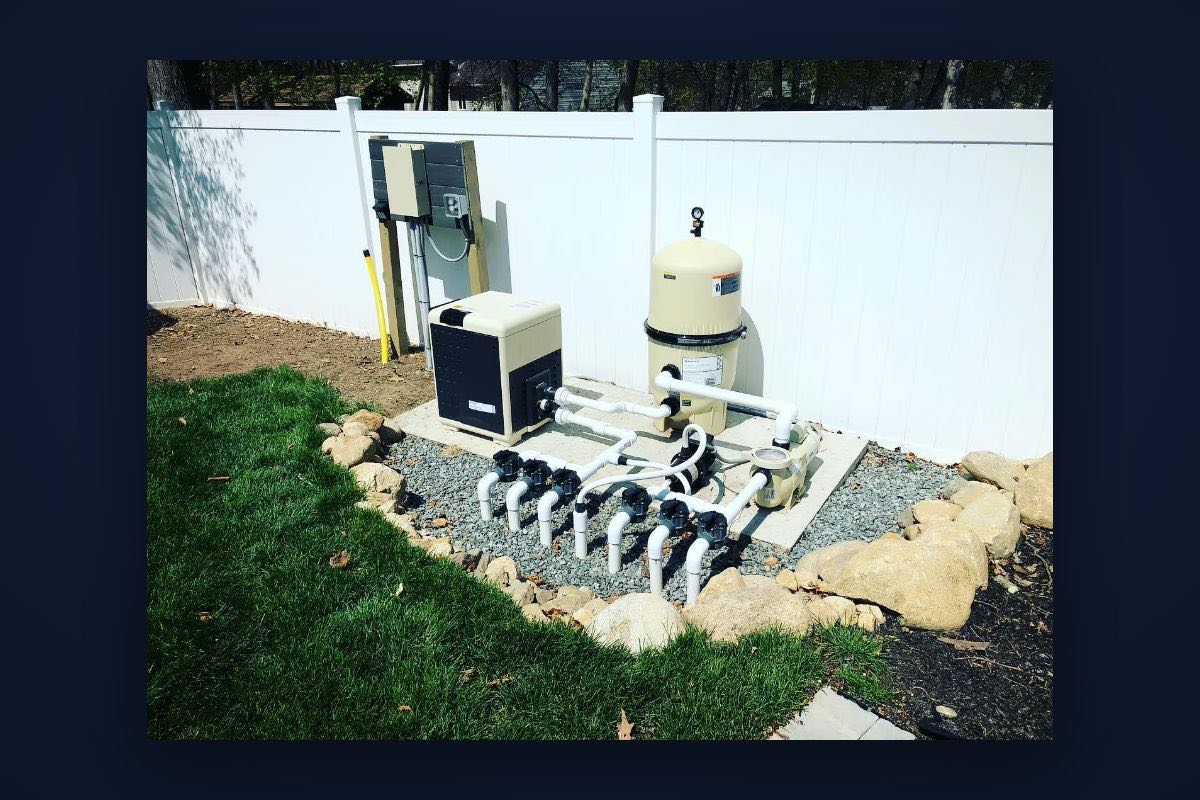 Pool equipment pad with heater, filter, pump, and electrical disconnect