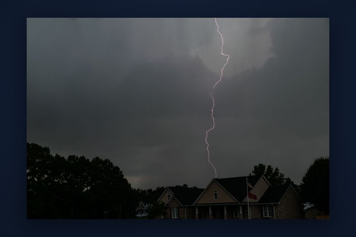 Lightning striking near a home during a storm