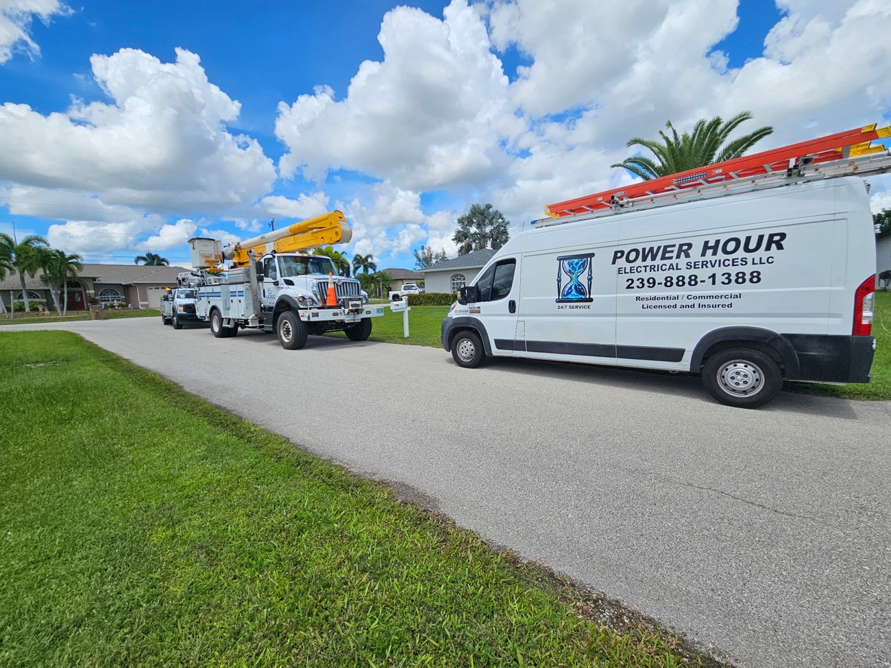 Power Hour Electrical van parked alongside an LCEC bucket truck and utility crew on a residential service call in Cape Coral