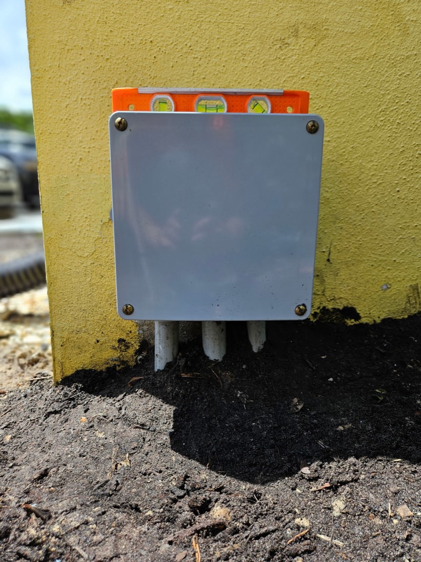 Clean weatherproof junction box neatly mounted and leveled after repair