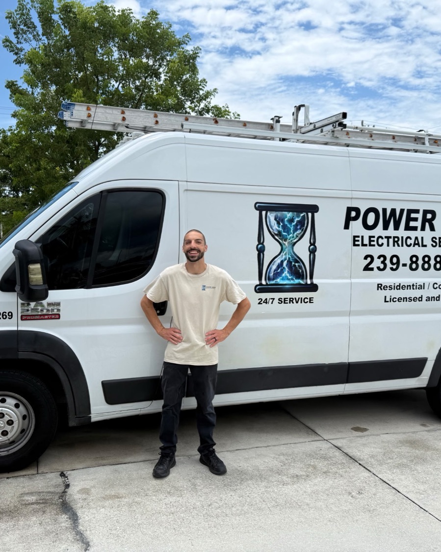Ravi Goldman standing in front of the Power Hour Electrical Services van