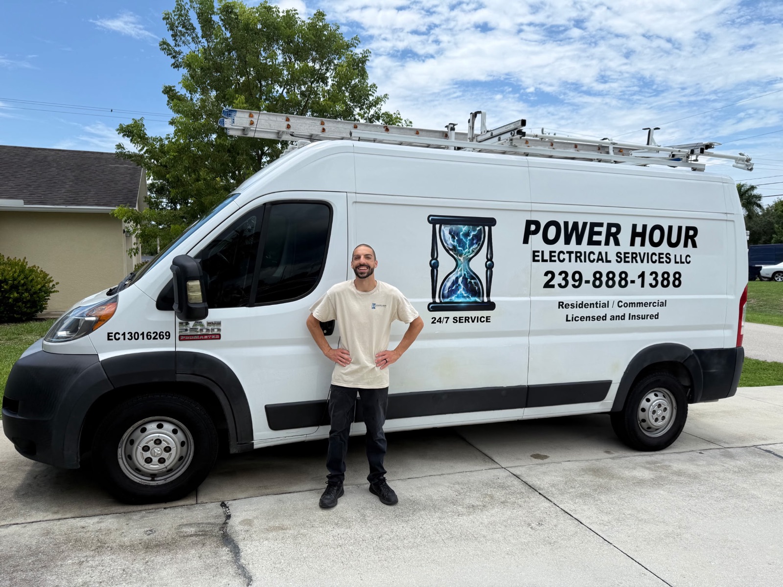 Ravi Goldman standing in front of the Power Hour Electrical Services van in Cape Coral