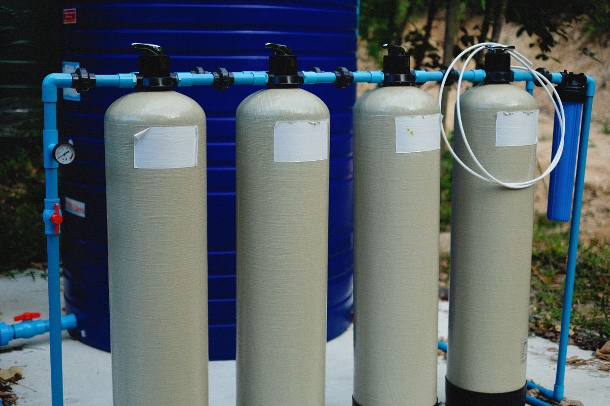 Pool equipment pad with pump, filter tanks, and piping
