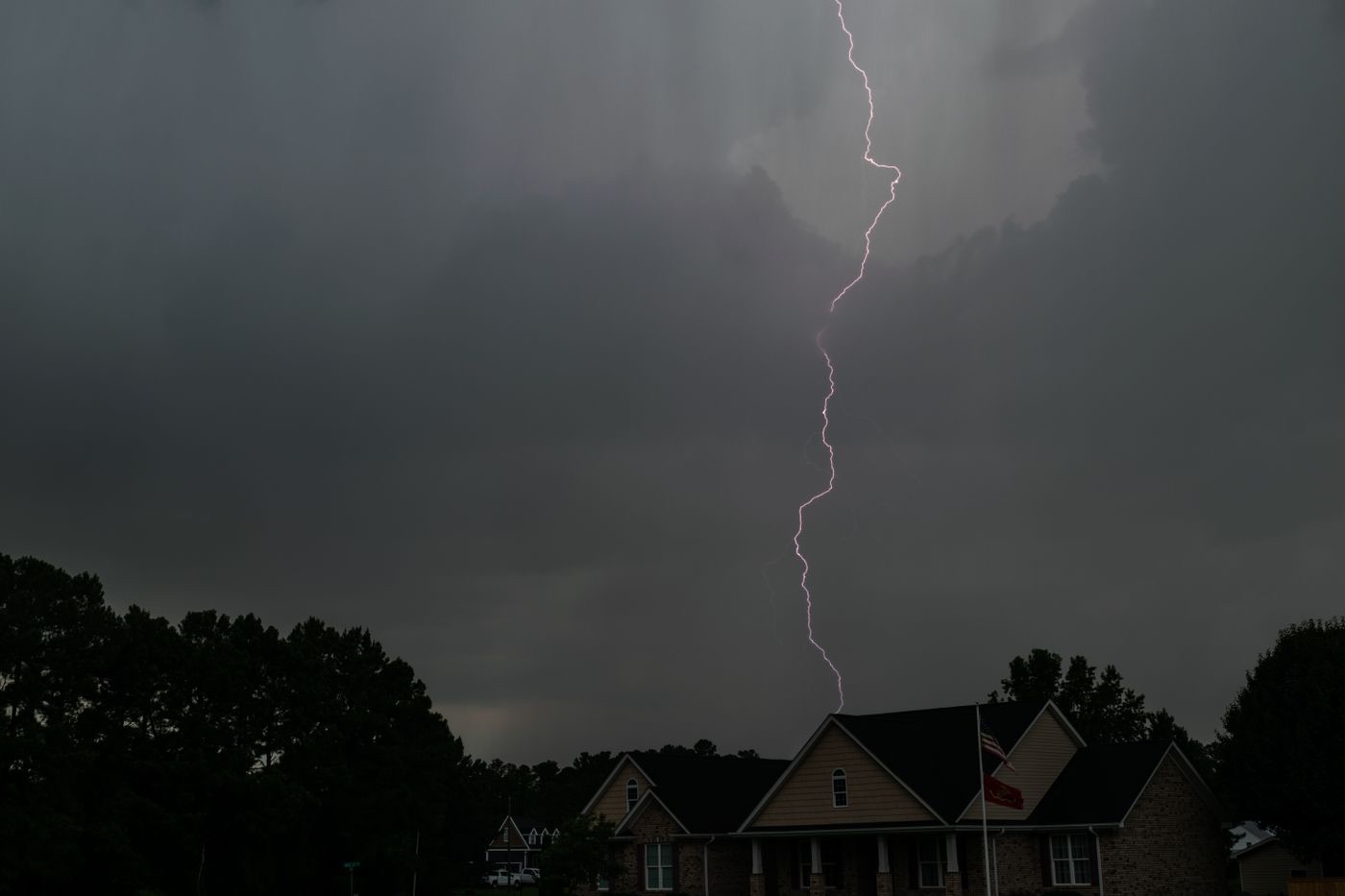 Lightning striking near a home during a storm